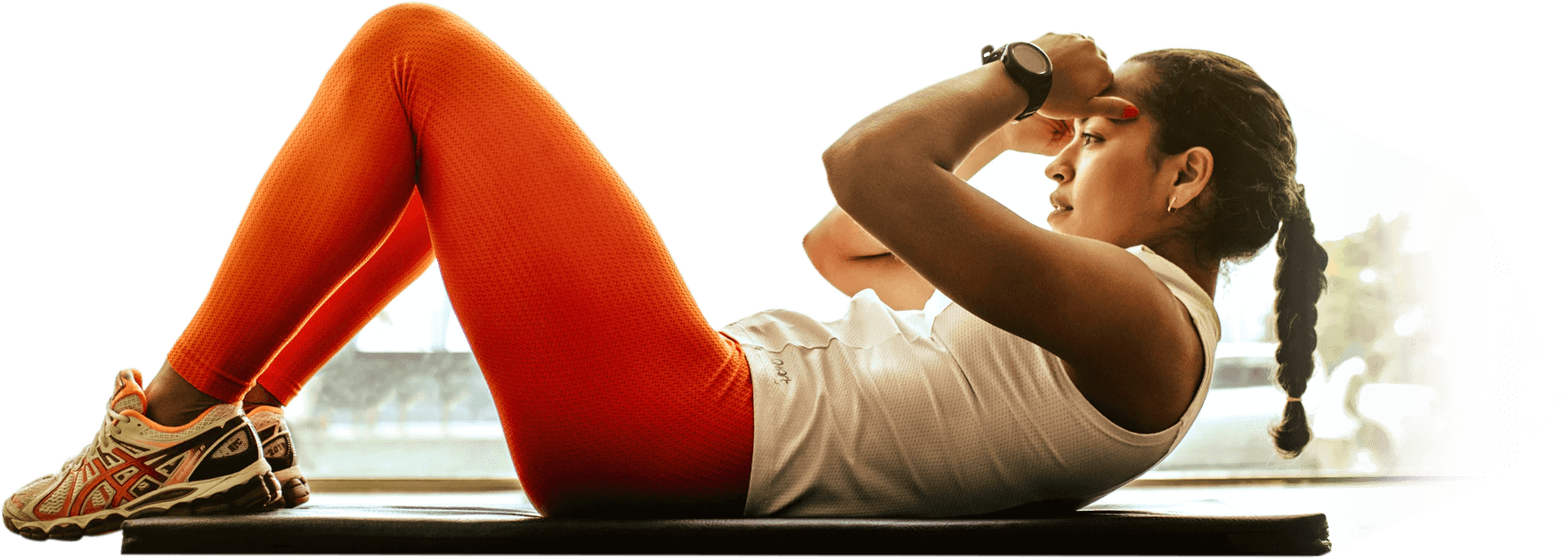 A woman is doing crunches on her stomach.